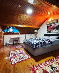 a bedroom with a bed and two rugs in a room at Elite Rooms in Fethiye