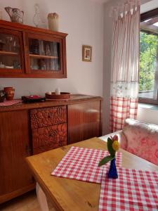 una cucina con tavolo e panna a scacchi rossa e bianca di Domek Cicho Sza a Rożdżały Altre 22 foto