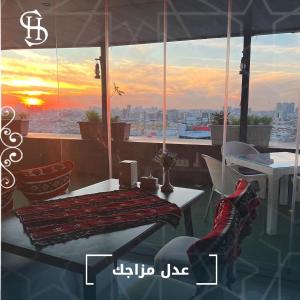 a picture of a balcony with a table and chairs at Sheek Hotel in Erbil