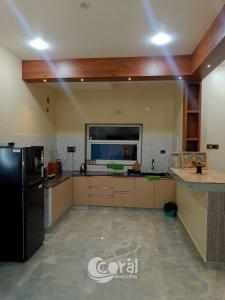 cocina grande con nevera negra en una habitación en Sea Breeze at ECR - Beach Front Villa with Private Pool, Jacuzzi and Dive-in Theater, en Tirupporūr