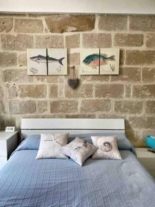 Ένα ή περισσότερα κρεβάτια σε δωμάτιο στο Casa Milo al Mare