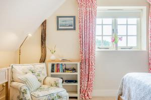 1 dormitorio con silla y ventana en Tiger Inn - Elizabeth, en Eastbourne