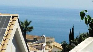 a view of the ocean from the roof of a building at Tropical Suite in Benalmádena