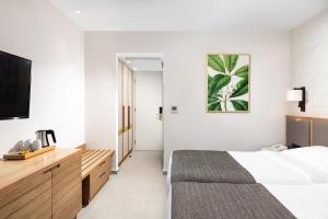 Postel nebo postele na pokoji v ubytování Platanista Hotel