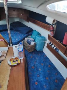 a bed and a table in the back of a boat at VRS - 21FT BOATEL AFURADA in Vila Nova de Gaia