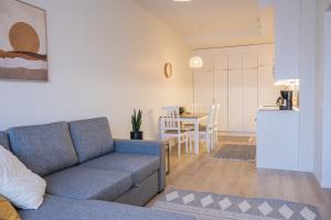 a living room with a couch and a kitchen at Snowflake Suites I in Rovaniemi