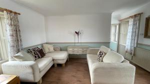 a living room with two couches and a table at North Middleton Apartment in North Middleton