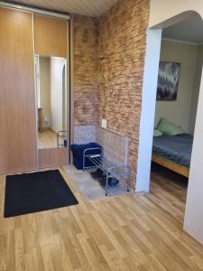 a living room with a brick wall and a fireplace at Apartments - Alauksta in Rīga