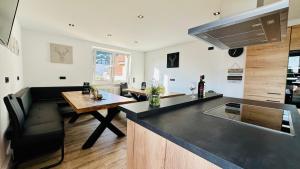 a kitchen with a table and a counter top at B&W Apartments in Morschen