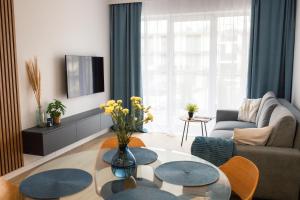 a living room with a couch and a table at Apartament Aleksandra SPA Dziwnów in Dziwnów