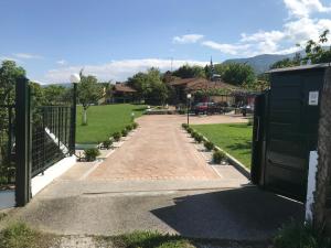 a driveway leading into a park with a gate at PARADISE VILLA in Litochoro