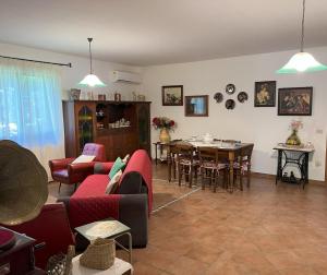 a living room with a couch and a table with chairs at Villa Franca in Castelluccio Inferiore