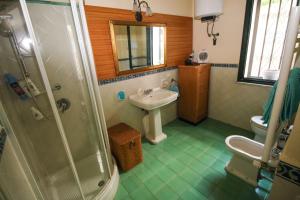 a bathroom with a sink and a toilet and a shower at Il Gelsomino in Palermo