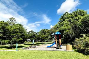 a playground with a slide in a park at Awesome Apartment near the Beach in Naples