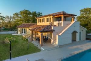 a house with a roof with a swimming pool at Villa Clara in Kavran