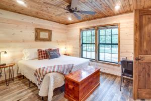 ein Schlafzimmer mit einem Bett und einer Holzdecke in der Unterkunft McAlester Vacation Rental with Private Hot Tub in McAlester