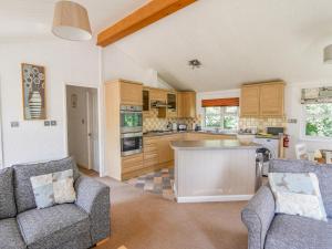 a kitchen with two chairs and a counter in a room at The Hideaway in Bridport