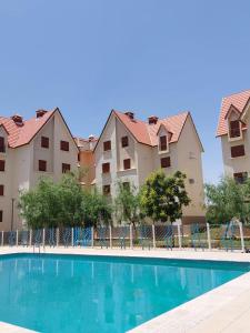 a swimming pool in front of some apartment buildings at Ifrane apartment with swimming pool in Ifrane