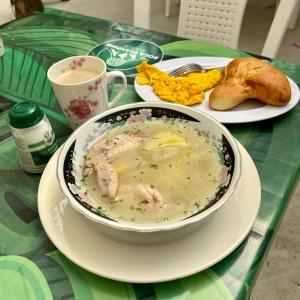 a table with a bowl of soup and a plate of food at DOMO Roca Glamping Suesca in Suesca