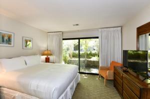 a hotel room with a bed and a television at 808 Augusta Cir home in Napa