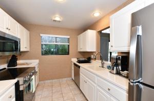 a kitchen with white cabinets and a stainless steel refrigerator at 808 Augusta Cir home in Napa
