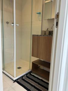 a shower with a glass door in a bathroom at Brás estudio confort in Sao Paulo