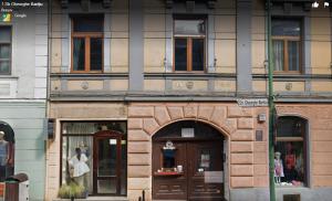 a brick building with two doors on a city street at Sophie's Place in Braşov