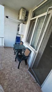 a patio with a table and chairs in a room at Apartament in Batumi