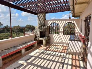 a patio with a bench and a grill on a building at The Penthouse at Lemiso road in Ngong