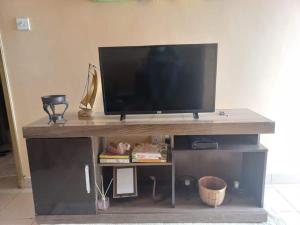 a flat screen tv sitting on top of a entertainment center at The Penthouse at Lemiso road in Ngong