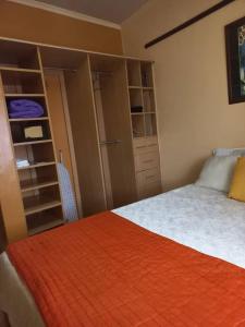 a bedroom with a bed with an orange blanket at The Penthouse at Lemiso road in Ngong
