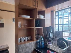 a kitchen with wooden cabinets and a counter top at The Penthouse at Lemiso road in Ngong
