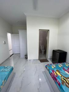 a white room with a bed and a bathroom at Moon light Hotel in Kafr Mas‘ūd