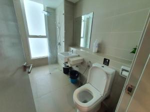 ein weißes Bad mit einem WC und einem Waschbecken in der Unterkunft Sutera Avenue KK Infinity Pool 10 mins to Airport 10 mins to Jetty LSS HomeStay in Kota Kinabalu