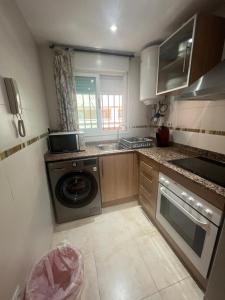 a kitchen with a washing machine and a washer at APARTAMENTO EN MARINA DOR (OROPESA) in Oropesa del Mar