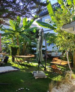 a patio with an umbrella and a table and chairs at Luna Alacati in Alacati