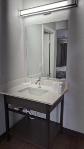 a bathroom with a sink and a large mirror at Motel 6-Nashua, NH - South in Nashua