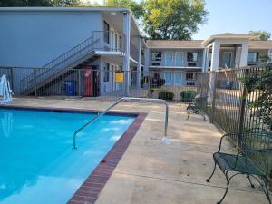a swimming pool in front of a apartment building at Super 8 by Wyndham Arkadelphia Caddo Valley Area in Arkadelphia