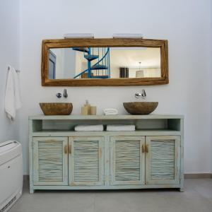 a bathroom with a sink and a mirror at White Dream Suites Antiparos in Andiparos