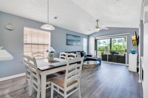 a dining room and living room with a table and chairs at Stunning 2BR Condo at Waterway Village in Myrtle Beach