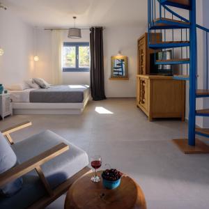 a living room with a bed and a blue ladder at White Dream Suites Antiparos in Antiparos