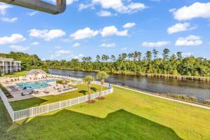 an aerial view of a resort with a river and a pool at Stunning 2BR Condo at Waterway Village in Myrtle Beach