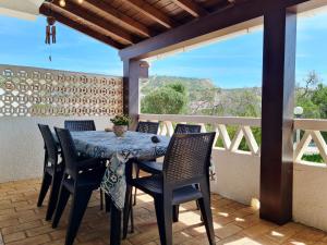 a blue table and chairs on a balcony with a view at REFÚGIO DO CARANGUEJO - Praia da Luz - WiFi, Private Pool & BBQ in Luz