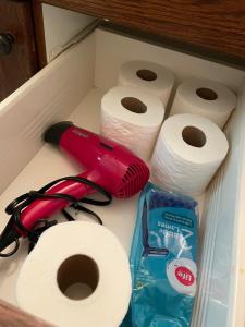 a drawer filled with toilet paper and a red brush at Campfire and Marshmallows in Sylvan Lake