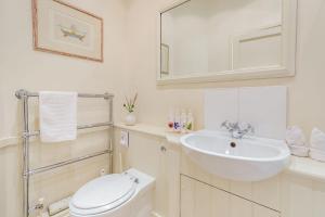 a white bathroom with a sink and a toilet at Tiger Inn - Catherine in Eastbourne