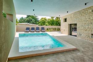 a swimming pool in the middle of a house at Villa Sponza in Medulin