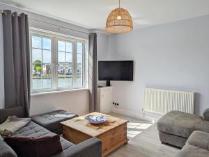 a living room with a couch and a table at Grace Cottage - Emsworth in Emsworth