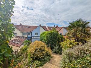 a row of houses with trees and bushes at Grace Cottage - Emsworth in Emsworth