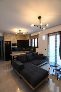 a living room with a couch and a kitchen at Athor Ireon Apartment 1 in Ireon
