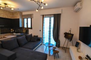 a living room with a couch and a table at Athor Ireon Apartment 1 in Ireon